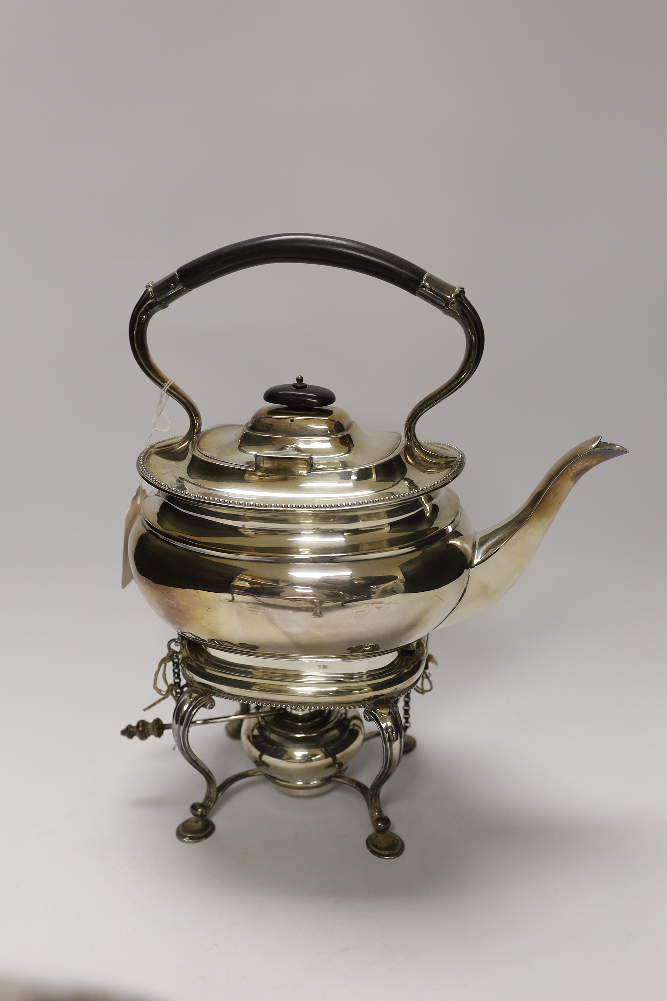 A plated breakfast dish with revolving lid and a tea kettle on burner stand, 31cm